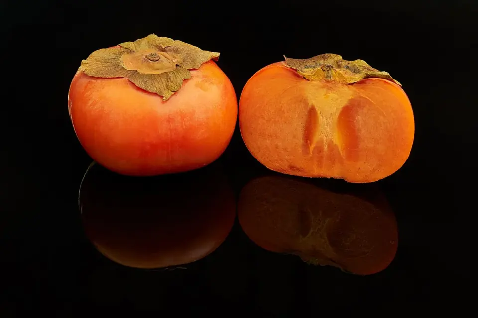 Whole and sliced Fuyu persimmons